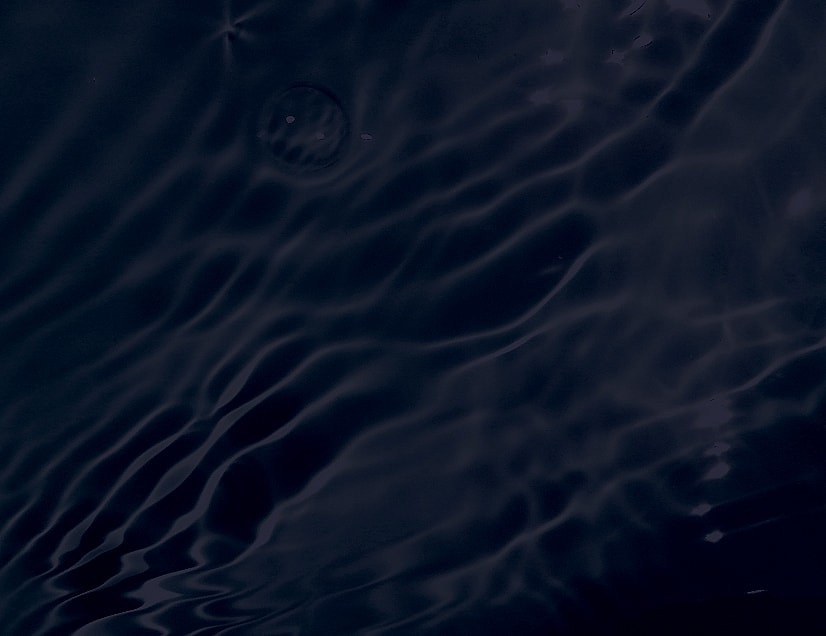 Dark water surface with smooth ripples.