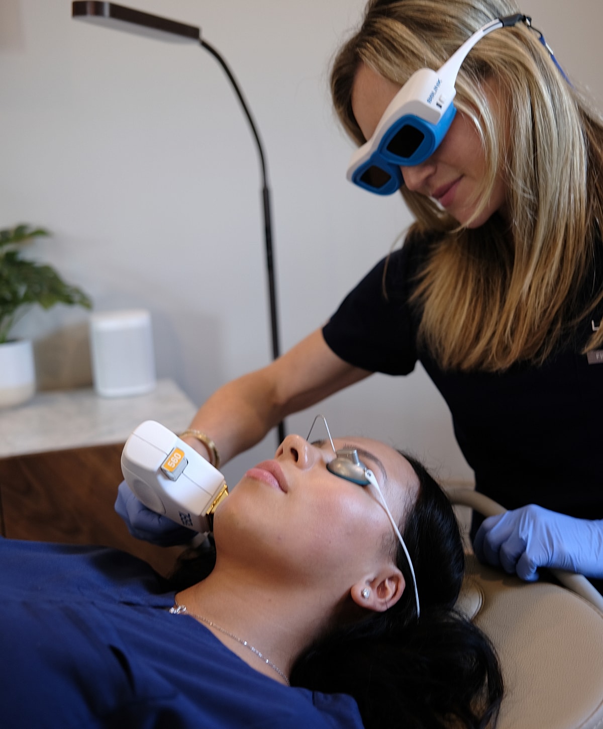 Woman receiving a facial treatment at clinic.