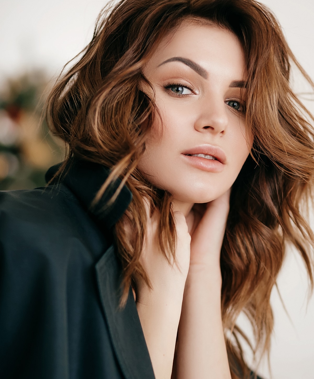 Woman with tousled hair and soft expression.