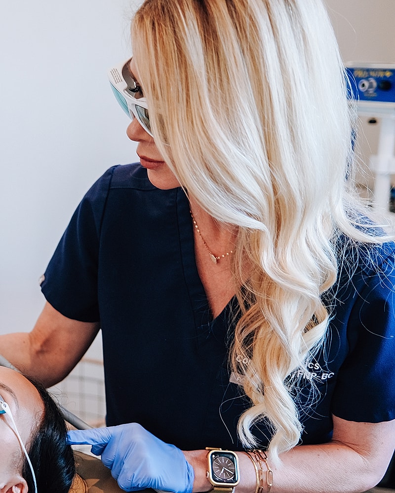 Healthcare professional assisting patient in treatment.