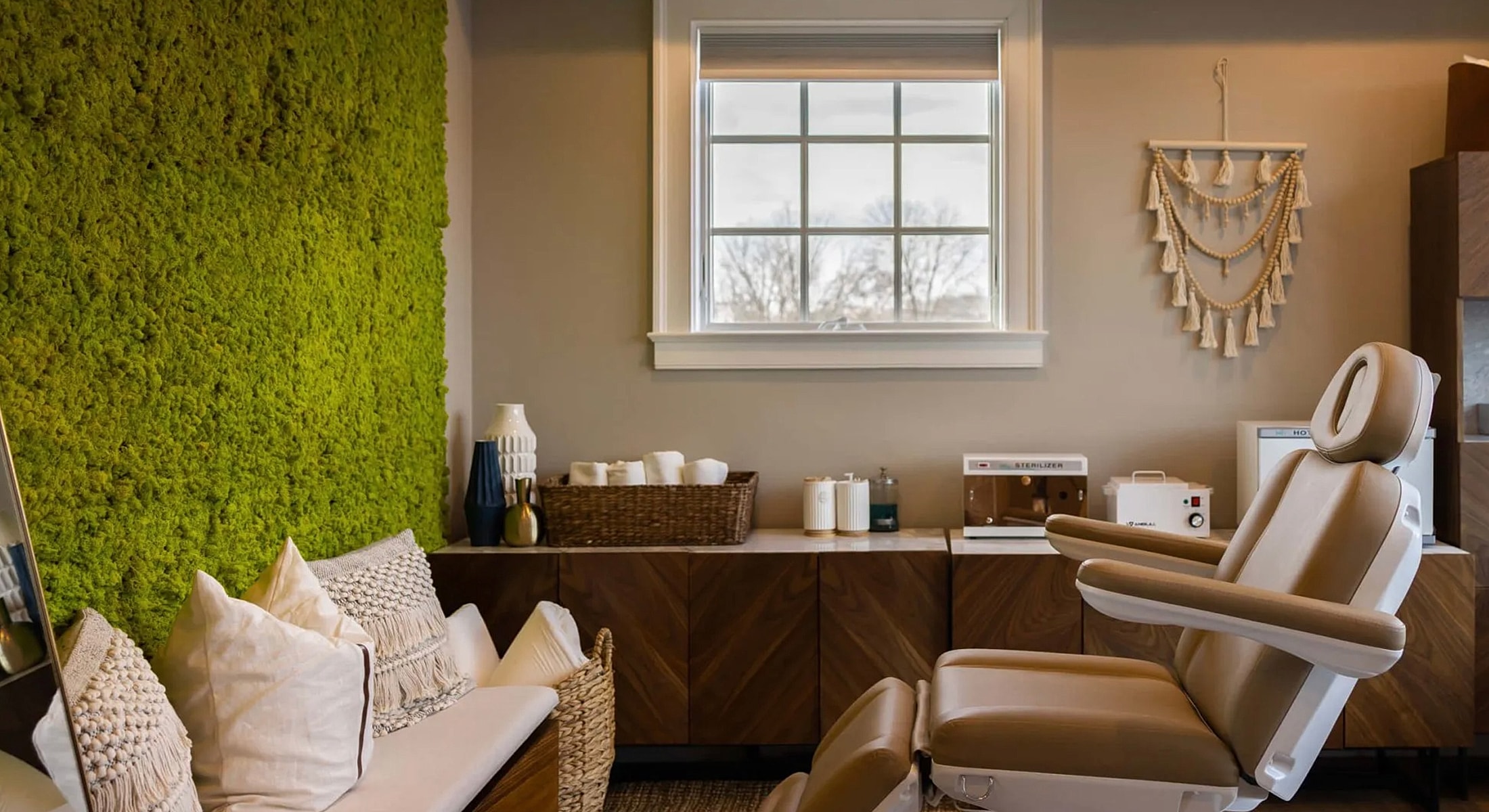 Modern treatment room with green moss wall.